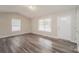 Sunlit living room showcasing hardwood flooring, neutral paint, a window, and a front entry door at 592 Rambo E Rd, Rock Hill, SC 29730