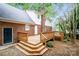 Home's backyard features a wooden deck, brick exterior, and a leafy surrounding at 721 Summerwood Dr, Rock Hill, SC 29732