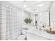 Well-lit bathroom featuring a large mirror, white vanity, and shower with curtain at 7407 Mystic Ln, Charlotte, NC 28227