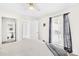 Bright bedroom features natural light, a ceiling fan, and ensuite access to the bathroom at 7407 Mystic Ln, Charlotte, NC 28227
