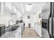 Galley kitchen featuring granite countertops, white cabinets, and stainless-steel appliances at 7407 Mystic Ln, Charlotte, NC 28227