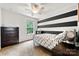 bedroom with black and white striped accent wall, a twin bed, and carpeted flooring at 8800 Darcy Hopkins Dr, Charlotte, NC 28277