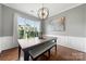 Bright dining room features hardwood floors, wainscoting, and modern lighting at 8800 Darcy Hopkins Dr, Charlotte, NC 28277