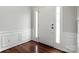 Inviting foyer with wood flooring, elegant molding, and a bright white front door at 8800 Darcy Hopkins Dr, Charlotte, NC 28277