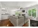 Bright living room with hardwood floors, fireplace, and open access to the kitchen and outdoor space at 8800 Darcy Hopkins Dr, Charlotte, NC 28277