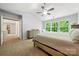 Comfortable bedroom featuring plush carpet, ensuite bathroom and natural light at 8800 Darcy Hopkins Dr, Charlotte, NC 28277