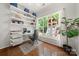 Bright office with wood floors, built-in shelves, and a large window overlooking a playground at 8800 Darcy Hopkins Dr, Charlotte, NC 28277