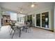 Covered outdoor patio with dining area, ceiling fans, and view of the backyard play set at 8800 Darcy Hopkins Dr, Charlotte, NC 28277