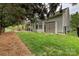 The backyard features a patio, grass, and storage shed, all surrounded by a fence at 1000 Millbank Dr, Matthews, NC 28104