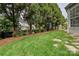 The lush green yard features a fenced perimeter, and steppers leading to the patio at 1000 Millbank Dr, Matthews, NC 28104