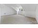 Large bonus room with carpet and natural light at 1000 Millbank Dr, Matthews, NC 28104