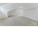 Large bonus room with carpet and natural light at 1000 Millbank Dr, Matthews, NC 28104