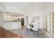 Sunlit dining area featuring a pendant light fixture, neutral tones and sliding glass door access to the outdoors at 1000 Millbank Dr, Matthews, NC 28104