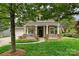Inviting front porch with brick-based columns, lush lawn, and well-maintained landscaping for relaxing curb appeal at 1000 Millbank Dr, Matthews, NC 28104