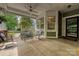 Relaxing front porch with comfortable seating, ceiling fan, and great views, perfect for enjoying the outdoors at 1000 Millbank Dr, Matthews, NC 28104