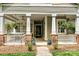 Charming front porch featuring a ceiling fan, potted plants, and comfortable seating area with a welcoming ambiance at 1000 Millbank Dr, Matthews, NC 28104