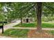 Charming home with a well-manicured lawn, mature trees, and classic curb appeal at 1000 Millbank Dr, Matthews, NC 28104