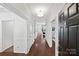 Inviting hallway features hardwood floors, white trim, and a view into the living area, creating a bright and open space at 1000 Millbank Dr, Matthews, NC 28104