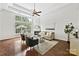 Cozy living room with fireplace, large windows, hardwood floors, and comfortable seating at 1000 Millbank Dr, Matthews, NC 28104