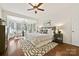Bright main bedroom with bay window, neutral tones, and hardwood floors at 1000 Millbank Dr, Matthews, NC 28104