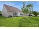 Lush backyard view features a well-maintained lawn and mature landscaping at 10314 Threatt Woods Dr, Charlotte, NC 28277