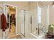Contemporary bathroom with a glass enclosed shower and acces to the closet at 10314 Threatt Woods Dr, Charlotte, NC 28277