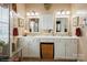 Bright bathroom with double vanity, white cabinets, mirrors and great natural light at 10314 Threatt Woods Dr, Charlotte, NC 28277