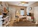 Comfortable bedroom featuring good natural light, a ceiling fan, a desk, and carpeted floors at 10314 Threatt Woods Dr, Charlotte, NC 28277