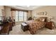Main bedroom with large windows, work space, wood furnishings and carpeted flooring at 10314 Threatt Woods Dr, Charlotte, NC 28277