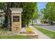 Attractive Auburn Place community sign framed by mature trees and colorful landscaping at 10314 Threatt Woods Dr, Charlotte, NC 28277