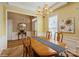 Dining room featuring a chandelier, wainscoting, and a neutral color palette at 10314 Threatt Woods Dr, Charlotte, NC 28277