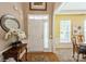 Inviting foyer with hardwood floors, neutral paint, and decorative accents at 10314 Threatt Woods Dr, Charlotte, NC 28277