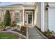 Inviting entrance with stone accents, decorative shutters, bench, and lovely landscaping at 10314 Threatt Woods Dr, Charlotte, NC 28277