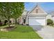 Charming home with a well-manicured lawn, two-car garage, and tasteful landscaping at 10314 Threatt Woods Dr, Charlotte, NC 28277