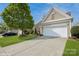 Charming home with a well-manicured lawn and two-car garage at 10314 Threatt Woods Dr, Charlotte, NC 28277