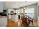 Bright kitchen with white cabinets, center island, and hardwood flooring at 10314 Threatt Woods Dr, Charlotte, NC 28277