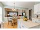 Kitchen with an island adjacent to a dining area with a chandelier and sunlit living room at 10314 Threatt Woods Dr, Charlotte, NC 28277