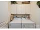 Functional laundry area with a washer, dryer and storage cabinets at 10314 Threatt Woods Dr, Charlotte, NC 28277