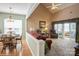 Living room featuring vaulted ceiling, fireplace, access to porch, and combination dining area at 10314 Threatt Woods Dr, Charlotte, NC 28277