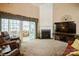 Cozy living room with fireplace, large TV, porch access, and ample seating at 10314 Threatt Woods Dr, Charlotte, NC 28277