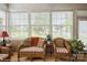 Bright sunroom with wicker furniture, a view of the backyard, and ample natural light at 10314 Threatt Woods Dr, Charlotte, NC 28277