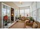 Sunroom featuring neutral tones, cozy wicker furniture, and views of backyard at 10314 Threatt Woods Dr, Charlotte, NC 28277