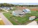 Aerial view of blue home, screened porch, large yard, black fence, matching shed and other blue house with three cars in driveway at 1050 Coppergate Dr, Salisbury, NC 28147