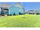 Large grassy backyard featuring beautiful landscaping and a charming sitting area offering a perfect blend of comfort and nature at 1050 Coppergate Dr, Salisbury, NC 28147