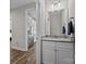 Powder room view into updated kitchen with stainless steel refrigerator and granite counters at 1050 Coppergate Dr, Salisbury, NC 28147