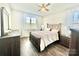 Cozy bedroom offers natural light and comfortable furnishings with wood-look flooring at 1050 Coppergate Dr, Salisbury, NC 28147