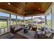 Inviting covered patio boasts wood ceiling, ceiling fan, fire pit, and comfortable seating perfect for relaxation and entertaining at 1050 Coppergate Dr, Salisbury, NC 28147