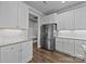 Bright kitchen features white cabinets, granite countertops, stainless steel appliances, and wood flooring at 1050 Coppergate Dr, Salisbury, NC 28147