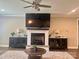 Cozy living room with a fireplace, built-in cabinets, and a ceiling fan for added comfort at 1050 Coppergate Dr, Salisbury, NC 28147