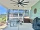 A screened porch with a picnic table, outdoor seating, and fan providing a cozy and comfortable outdoor living space at 1050 Coppergate Dr, Salisbury, NC 28147
